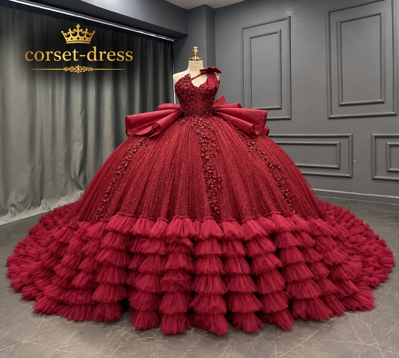 Burgundy couture ball gown displayed in a showroom